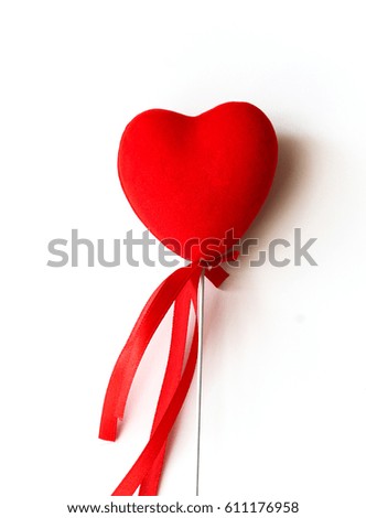 Red shape of heart with red ribbon on white background. Small gift on Valentine's day for your loved one
