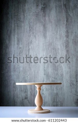 empty stand for Cake on gray background Royalty-Free Stock Photo #611202443
