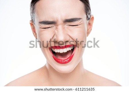 Close up portrait of young woman screaming isolated on white