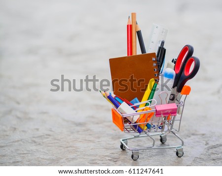 Shopping cart with school supply. Back to school concept.