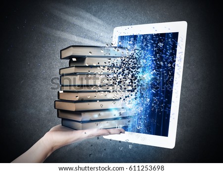 Reading books with an E-book Royalty-Free Stock Photo #611253698