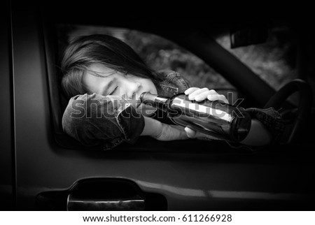 Woman drunk in the car,Alcoholism,Drunk woman,Dangerous on road,Don't drink and drive concept,Black and white