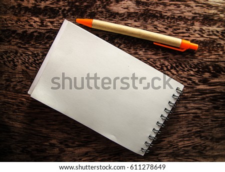 Blank paper with pen on wood table 