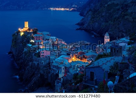 Aerial view of beautiful Vernazza in peaceful morning twilight ~ an amazing fishing village of colorful houses perched on vertical cliffs at the rocky coast in Cinque Terre, Italy, Europe