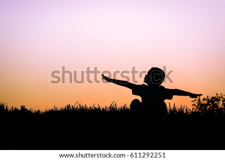 Child with arms outstretched. Freedom and happiness concept.