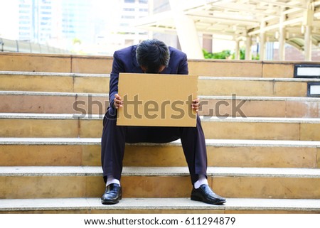 Stressed man sitting with blank card for insert your text at stairs for failure concept.