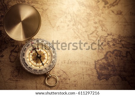 Retro compass with vintage map Royalty-Free Stock Photo #611297216