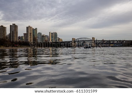 Ferry boat in False Creek with Burrard Bridge in the background. Picture taken in Downtown Vancouver, BC, Canada.