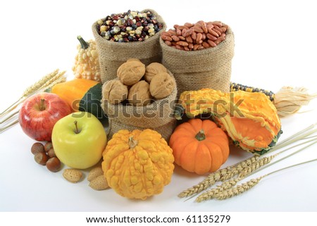 Still Picture of pile from Fall Fruits, Nuts and Gourds (squashes) over white background.