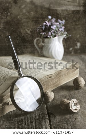 old scratched effect on photo magnifying glass and old book