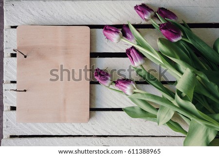 Notebook mock up with  fresh tulips on white rustic background