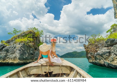 Young woman traveler on longtail boat trip at island hopping  Thailand Royalty-Free Stock Photo #611408984