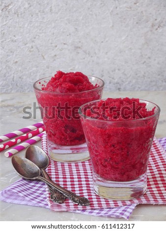 Raspberry sorbet in glasses. Frozen berry dessert on light background. Pink ice cream. Space for text