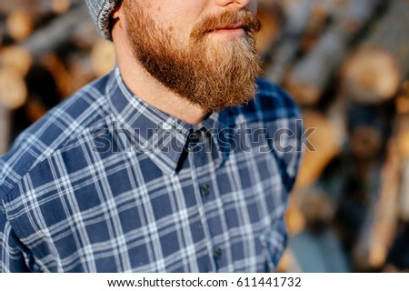 Portrait of handsome single bearded young man with serious expression 