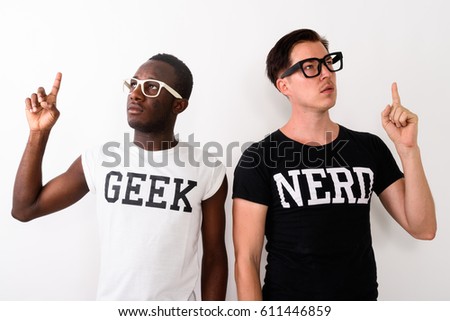 Studio shot of young black African Geek man with European Nerd man thinking and having great idea while pointing finger up against white background