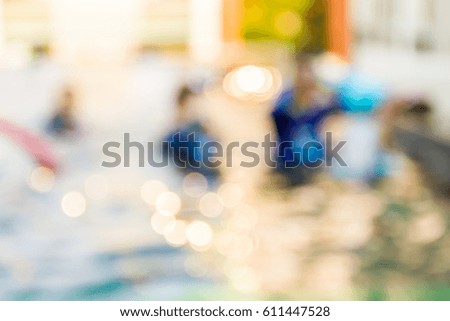 Blur image of people are swimming in the pool, use for background.