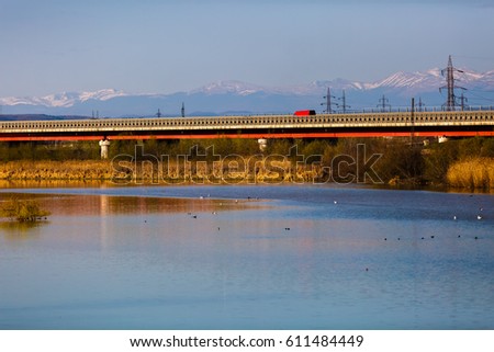 bridge over the river with mountains in the background