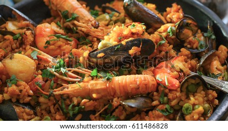Extreme close up view of delicious Spanish seafood paella: mussels, king prawns, langoustine, haddock Royalty-Free Stock Photo #611486828