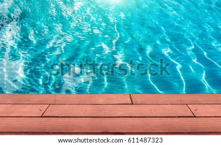 abstract wood plate on pool water in summer day