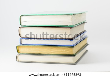 Many closed books lying on a white background. Horizontal.