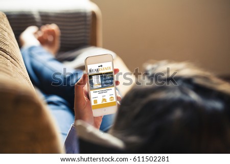 Woman searching for house through mobile phone in a real estate app while lying on the sofa at home. Website template design  specifically designed and released.
