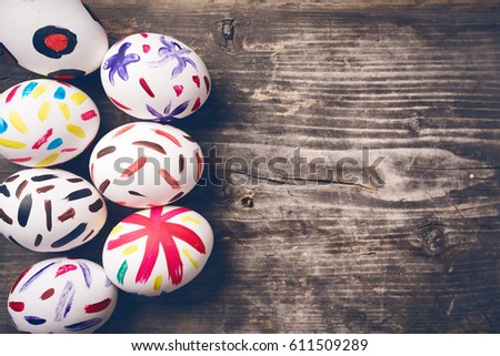 Easter Eggs on old boards. Painted eggs. Old board background. Easter ideas. Easter eggs. Space for text. Image in trendy toning.