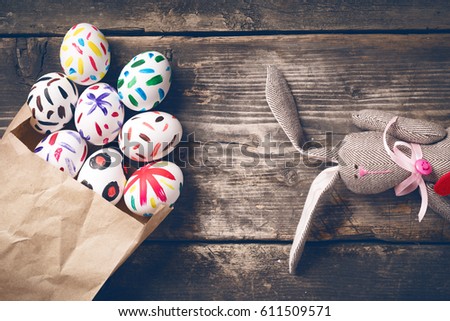 Easter bunny on old boards. Old board background. Rabbit. Easter ideas. Easter eggs. Space for text. Image in trendy toning. On the heart text happy Easter.
