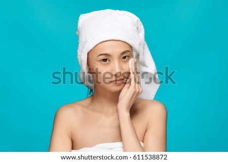       Asian woman with a towel on her head, clean skin, facial,                         