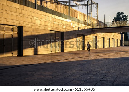 Aged sportsman running on country road, healthy inspirational fitness lifestyle, sport motivation speed interval training. Runner jogging training and doing workout exercising power outdoors in city.