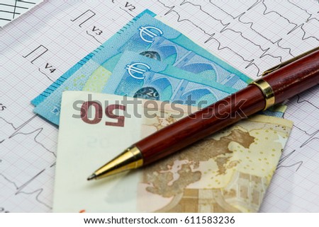 Stethoscope and money on electrocardiogram, symbol for health care costs or medical insurance. With euro.