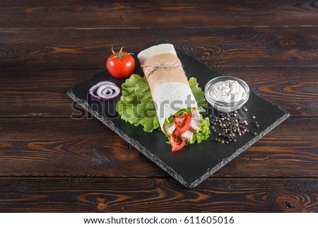 Burrito with chicken and tomato. View 45 degrees (A series of different types of Burrito for menus photographed from one angle)