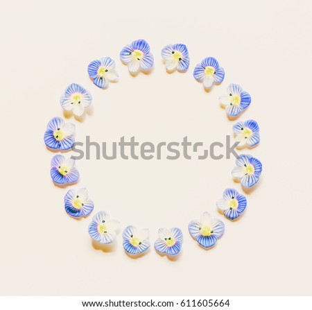 Round vintage frame made of small blue flowers on a white background with space for text. Flat lay, top view. mock up for text, phrases, congratulations, lettering