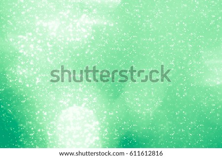 Green abstract Spring background. Bokeh or round defocused particles or glitter lights