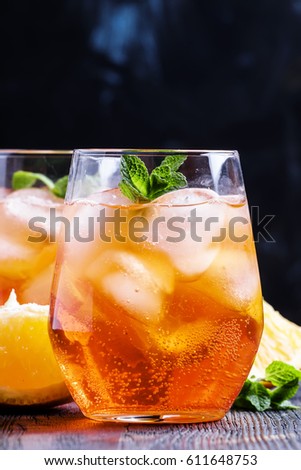 Italian cocktail with aperitif, ice and orange, selective focus