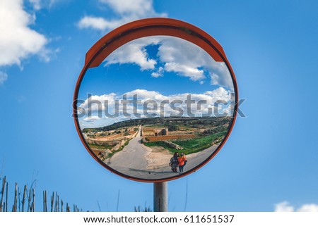 Road mirror. Landscape of Malta with road and two girls in street mirror. Royalty-Free Stock Photo #611651537