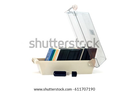 Plastic box for floppy disk isolated on the white background with the black USB flash drive.