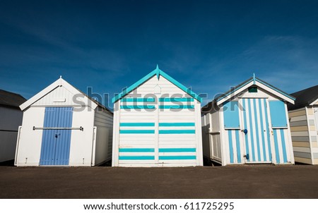 Traditional English Beach Huts. A row of traditional English beach huts commonly found in seaside resorts.