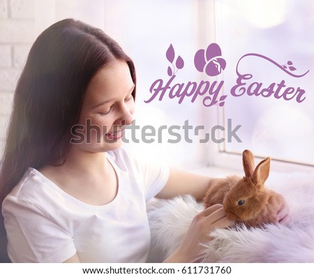 Cute girl with little bunny near window and text HAPPY EASTER on background