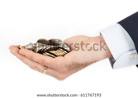 Businessman hand holding a pile of euro coins on white background. Business concept.