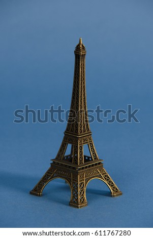 Eiffel tower from Paris in studio against blue background