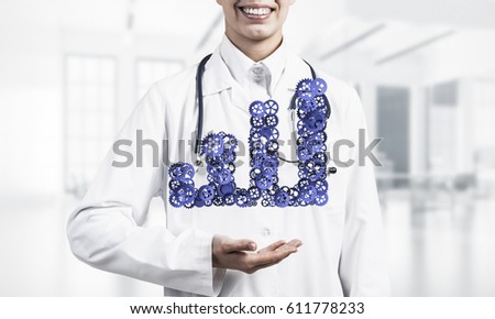 Close of doctor hands holding in palms growing graph made of gears