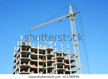  Tower Crane Picture with copy space.  House Construction Building Site. Tower Crane, building construction site with contractor on the top.