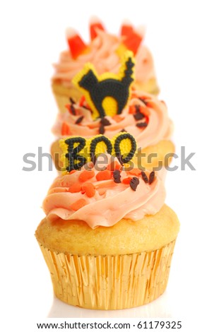 Three delicious Halloween cupcakes with holiday decorations