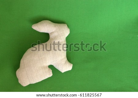 Handmade rabbit  on green background
