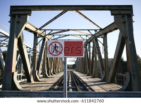 Blank empty banner in front of old railroad bridge no trespassing
