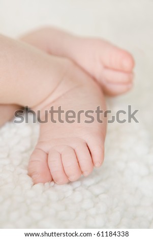 closeup picture of newborn baby feet with selective focus on the closest foot