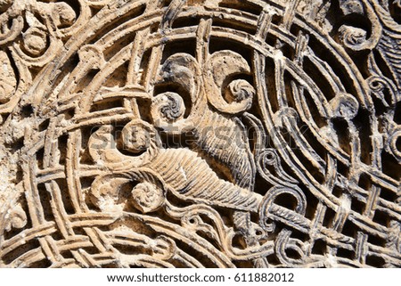 Detail of a beautiful old crumbling abstract stone decoration