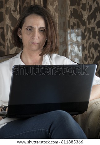 Young woman with laptop in a living room