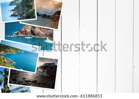 Vacation pictures on a wooden white table. View from above.