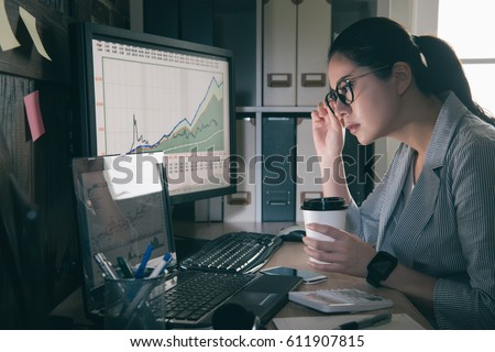 beautiful business woman working at the retro office with laptop have financial issues. girl grip glasses and pick up coffee cup focus on graph.